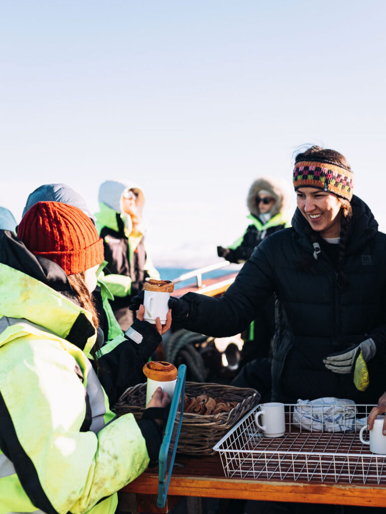 Crew serving hot chocolate onboard